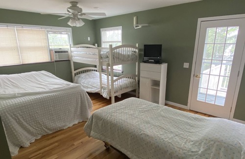 Gwinn Cottage | Beach front lake home, sleeps 8, hot tub, lots of outdoor spaces, docks.