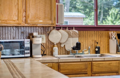 Fountain Cabin | Charming Green Cabin with Dock, Kayaks, Round Lake Access, Minutes to Ludington