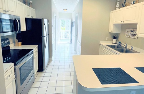 Central Myrtle Beach Condo | Endless Summer Coastal Condo at Magnolia Place - Pool & Golf Course Views!