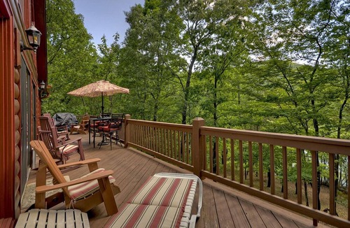 Walnut Mountain Cabin | Experience Lakeview Retreat, where pets are pampered by the shimmering waters. Unwind in a hot tub, enjoy WiFi, and a full game room w/pool table