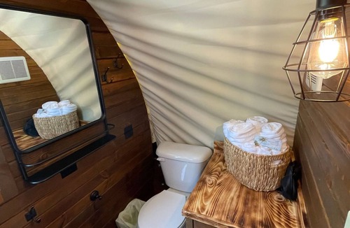 Branson Cottage | Oregon Trail Wagon has two queens size bed, bathroom w/shower, heat & a/c, smart tv, wi-fi, microwa