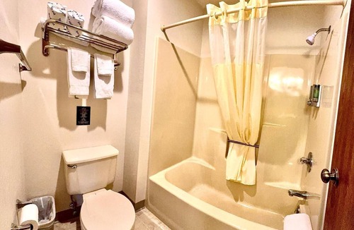Boulder Junction Apartment | Stay in comfort in this room featuring two queen beds, a private bathroom, sitting area, mini fridge, and single-serve coffee maker. Guests also have access to a microwave in the lobby. Perfect for couples, friends, or families looking for a cozy and
