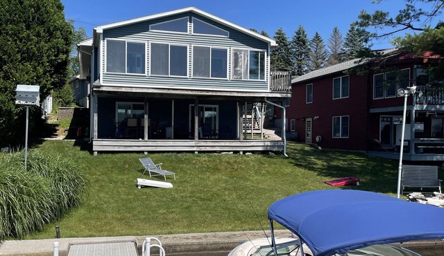 Beautiful Waterfront home with deep water dock on Onota Lake. Huge covered deck.