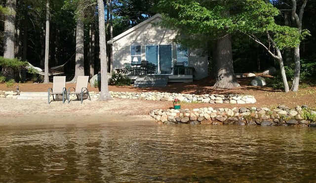 Charming lakefront cottage with sandy beach on a large private wooded lot in Milton