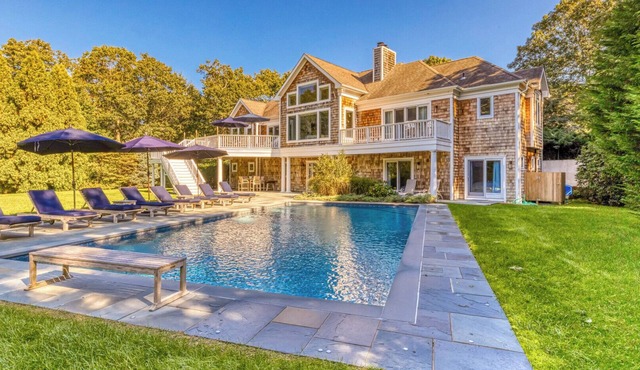 Modern, coastal-style home with flooding natural light, a private pool, a.