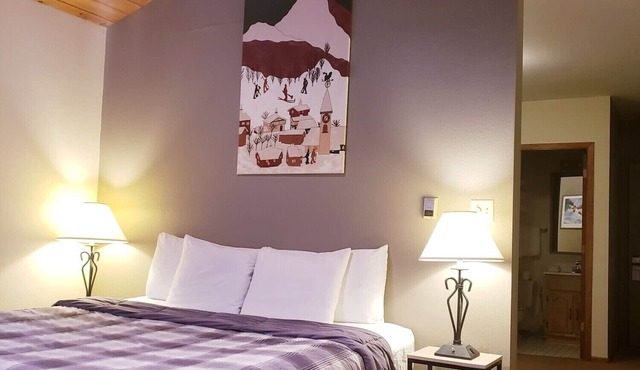 Private King Suite ideal for couples/romantic stays, and single travelers featuring a beautiful knotty pine vaulted ceiling. Dog friendly!