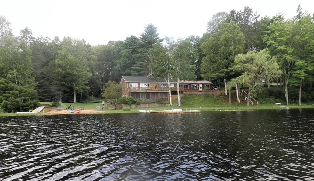 SECLUDED LODGE WITH ONE OF THE LARGEST PRIVATE STOCKED LAKES IN MICHIGAN.